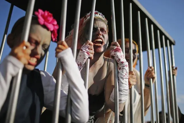 Revellers take part in a Zombie Walk in Asbury Park, New Jersey October 4, 2014. (Photo by Eduardo Munoz/Reuters)