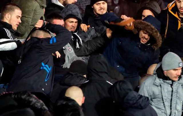 Two groups of Partizan Belgrade' s supporters clash during the Serbian Superleague derby football match between Partizan Belgrade and Crvena Zvezda (Red Star), on December 13, 2017 in Belgrade. (Photo by Pedja Milosavljevic/AFP Photo)
