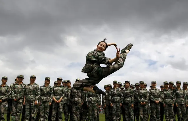 A student dances as she performs for her fellow students while they take a break from their military training in Kunming, Yunnan province, China, September 17, 2015. (Photo by Wong Campion/Reuters)