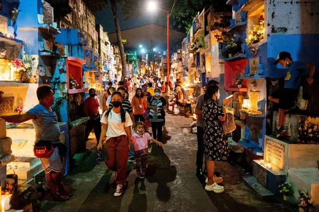People arrive at the Barangka Cemetery during All Saints' Day, in Marikina City, Metro Manila, Philippines on November 1, 2022. (Photo by Lisa Marie David/Reuters)