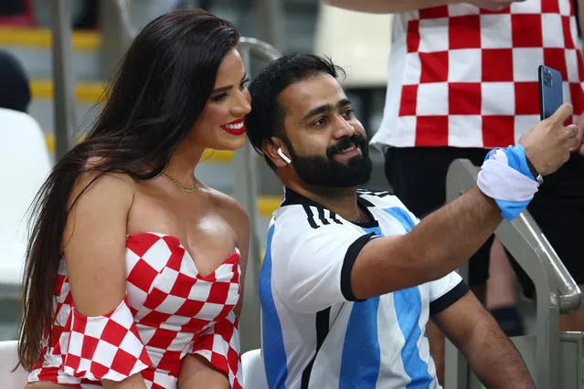 Former Miss Croatia, Ivana Knoll poses with a fan prior to the FIFA World Cup Qatar 2022 semi final match between Argentina and Croatia at Lusail Stadium on December 13, 2022 in Lusail City, Qatar. (Photo by Chris Brunskill/Fantasista/Getty Images)