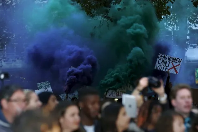 Demonstrators let off flares in the crowd during the Gala screening of the film "Suffragette" for the opening night of the British Film Institute (BFI) Film Festival at Leicester Square in London October 7, 2015. (Photo by Luke MacGregor/Reuters)