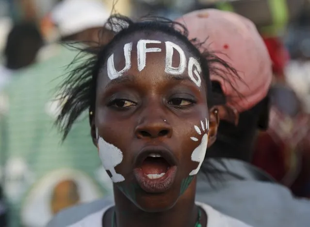 A supporter of former prime minister and presidential candidate Cellou Dalein Diallo of the Union des forces democratiques de Guinee (UFDG ) shouts while she attends a campaign rally at the yard next to the parliament building in Conakry October 8, 2015. Guinea will hold its presidential election on Sunday. (Photo by Luc Gnago/Reuters)