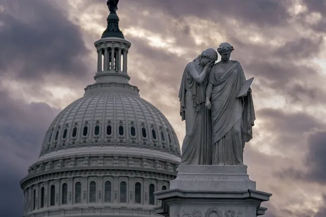 The Peace Monument and the Capitol Dome are seen amid cloudy skies as the House of Representatives struggles to elect a speaker and convene the 118th Congress with a new Republican majority, at the Capitol in Washington, early Thursday, January 5, 2023. (Photo by J. Scott Applewhite/AP Photo)