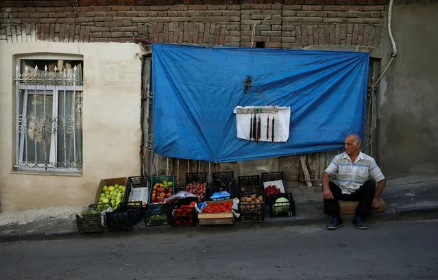 A man sells fruits and vegetables on the street in Tbilisi, Georgia, September 13, 2016. (Photo by David Mdzinarishvili/Reuters)