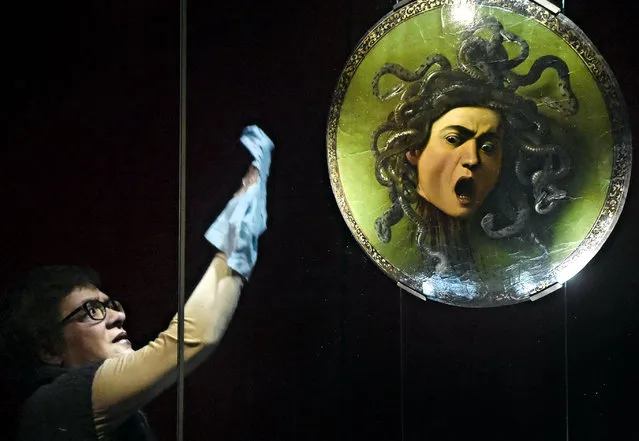 A woman cleans the glass display of the artwork “Medusa” by Italian painter Michelangelo Merisi da Caravaggio that is exhibited as part of a new set-up of rooms dedicated to Caravaggio and the 17th century painting at Galleria degli Uffizi (Uffizi Gallery) in Florence, Italy, 19 February 2018. “Medusa”, the famous painting on the shield, will be the “star” work of a group of eight new rooms dedicated by the museum to masterpieces of Caravaggio and other 17th century painters, Italian and beyond, such as Artemisia Gentileschi, Gherardo delle Notti, Velazquez, Rembrandt, Van Dyck and Rubens. (Photo by Maurizio Degl Innocenti/EPA/EFE)