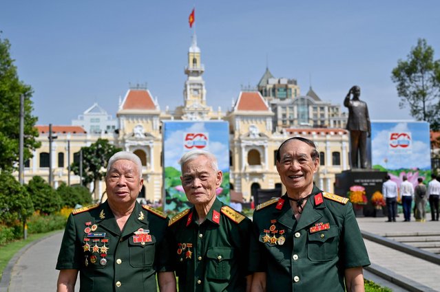 Vietnamese veterans pose for a photo in front of the Ho Chi Minh City People's Committee Building in Ho Chi Minh City on April 29, 2025, ahead of the celebrations on April 30 to mark 50 years since the communists of North Vietnam defeated the US-backed South in a victory that ended the Vietnam War. (Photo by Nhac Nguyen/AFP Photo)
