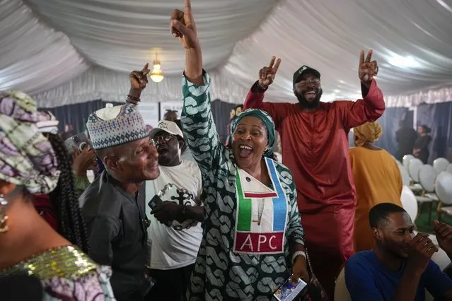 Supporters of Presidential candidate Bola Tinubu of the All Progressives Congress celebrate ahead of the final declaration of election results, at his campaign headquarters in Abuja, Nigeria Wednesday, March 1, 2023. Tensions rose in Nigeria Tuesday as the main opposition parties demanded a revote for the country's presidential election, where the latest results show an early lead for the ruling party. (Photo by Ben Curtis/AP Photo)