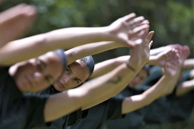 Female voluntary recruits attend a three month training program at a military base in Bogota, Colombia, Monday, March 6, 2023. After a 25-year ban, the Colombian army is once again allowing women to join its ranks through voluntary military service, which is a requirement for men. (Photo by Fernando Vergara/AP Photo)