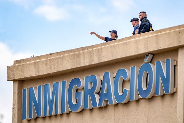 FBI agents stand on the roof of an immigration lawyer's office building across the street from the Immigration and Customs Enforcement (ICE) field office where a shooting took place, in Dallas, Texas on September 24, 2025. (Photo by Jeffrey McWhorter/Reuters)