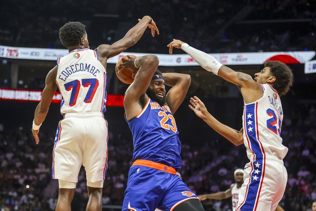 New York Knicks center Mitchell Robinsons (23) gets double teamed by Philadelphia 76ers VJ Edgecombe (77) and Dominick Barlow (25) during the NBA Abu Dhabi match at Etihad Arena on October 2, 2025. (Photo by Victor Besa/The National)