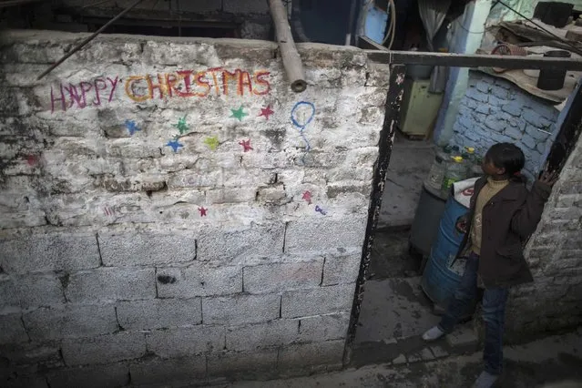 A girl stands at an entrance of her house ahead of Christmas in a Christian slum in Islamabad December 24, 2014. (Photo by Zohra Bensemra/Reuters)
