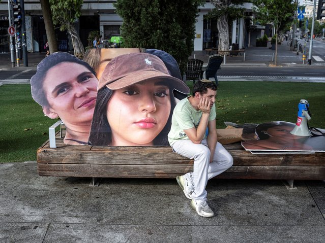 A person sits as supporters and families of hostages, who were kidnapped during the deadly October 7 attack by Palestinian Islamist group Hamas, rally demanding release of hostages as part of a deal being advanced by U.S. President Joe Biden, at Dizengoff square in Tel Aviv, Israel on June 5, 2024. (Photo by Marko Djurica/Reuters)