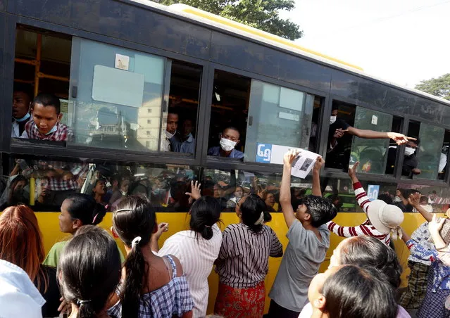 Relatievs and friends gather around a bus carrying inmates upon their release from Insein prison in Yangon, Myanmar, 04 January 2023. The Myanmar military council granted amnesty to over seven thousand people across the country to mark the Independence Day. (Photo by Nyein Chan Naing/EPA/EFE)