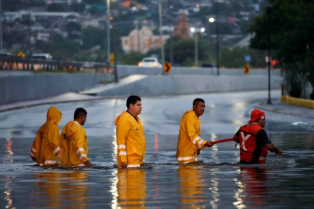 Government employees work to drain a flooded overpass as tropical storm Alberto continues to advance, in Monterrey, Mexico on June 20, 2024. (Photo by Daniel Becerril/Reuters)