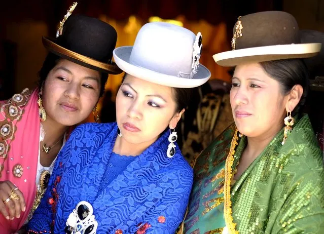 Aymara models look on at the fair of the Cholita garb show in Villa Esperanza in El Alto, outskirts of La Paz, November 18, 2015. (Photo by David Mercado/Reuters)