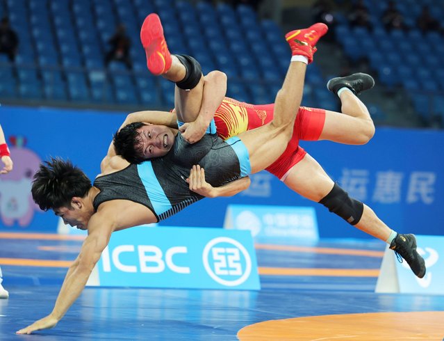 Jin Wenmeng (R) of Yunnan competes against Huang Jinbin of Chongqing during the men's freestyle 74kg match of wrestling at China's 15th National Games in Qingyuan, south China's Guangdong Province, November 11, 2025. (Photo by Li Ran/Xinhua/Alamy Live News)