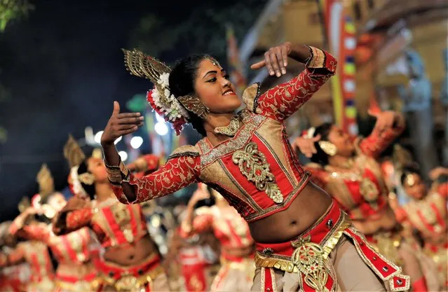 Traditional dancers perform during the annual Nawam Maha Perahera of Gangaramaya Buddhist temple in Colombo, Sri Lanka on February 5, 2023. (Photo by Dinuka Liyanawatte/Reuters)