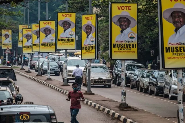 Billboards of Uganda's President Yoweri Museveni who is running for his 6th presidential term are seen on a street in Kampala, Uganda, on January 4, 2021. Uganda gears up for presidential elections which is scheduled to take place on January 14, 2021, as President Yoweri Museveni seeks another term to continue his 35-year rule. (Photo by Sumy Sadurni/AFP Photo)