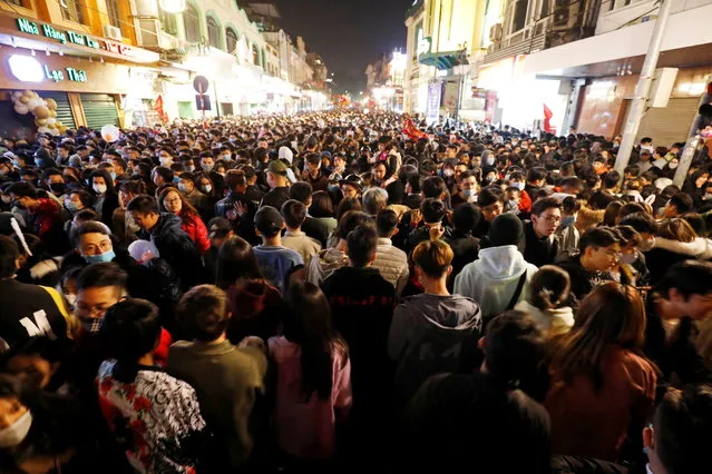 People gather on a street during New Year's Eve celebrations amid coronavirus disease (COVID-19) pandemic, in Hanoi, Vietnam on January 1, 2021. (Photo by Kham via Reuters)