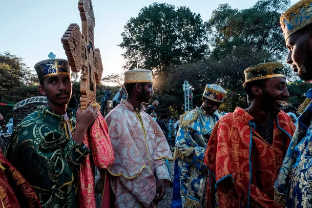 Ethiopian Orthodox Christian worshippers hold crosses during the celebration of Timkat, the Ethiopian Epiphany, in Gondar, Ethiopia, on January 18, 2021. (Photo by Eduardo Soteras/AFP Photo)