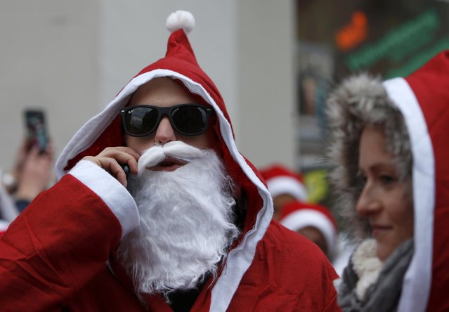 People dressed as Santa Claus take part in the 22nd Santa Claus meeting in Auerbach, Germany, December 6, 2015. (Photo by Michaela Rehle/Reuters)