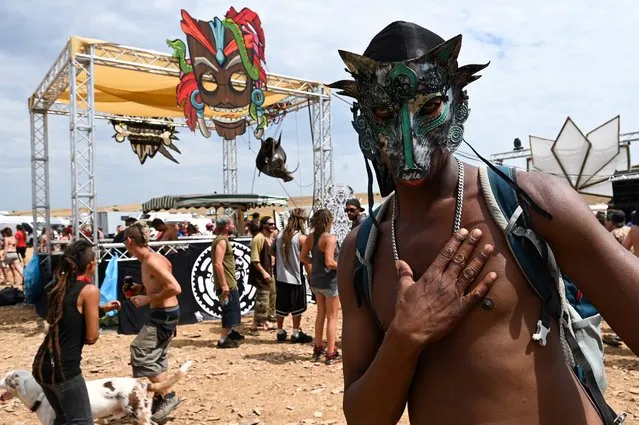 People dance and attend a rave party, on an agricultural land in Causse Mejean, in the heart of the Cevennes National Park, southern France on August 10, 2020, despite the limitation of gatherings linked to COVID-19, the novel coronavirus. The rally gathered up to 10,000 people announced the prefecture of Lozere. Starting from August 9, 2020 at 8:00 am, the gendarmes had blocked the access to prevent other people from joining the party where there were also very young children, according to the prefect. Two Covid-19 screening centers are being set up in transit areas, near the site, to be operational on Tuesday morning, also said Ms. Hatsch. (Photo by Pascal Guyot/AFP Photo)
