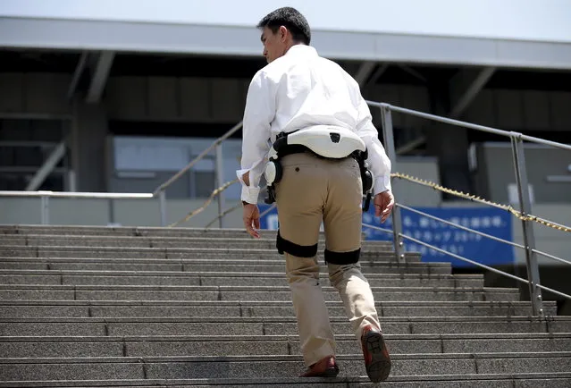 A Honda Motor employee demonstrates the company's new Walking Assist Device, which helps those with weakened leg muscles but who are still able to walk, during its unveiling in Tokyo, Japan July 21, 2015. (Photo by Toru Hanai/Reuters)