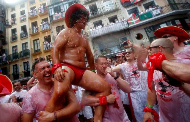 Revellers play and celebrate during the opening of the San Fermin festival in Pamplona, Spain, July 6, 2018. (Photo by Joseba Etxaburu/Reuters)