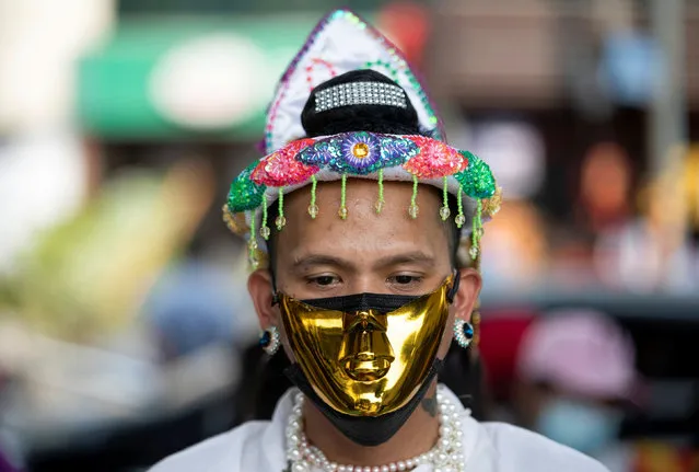 A demonstrator wearing a golden mask during a protest against the military coup in Yangon, Myanmar on February 21, 2021. (Photo by Reuters/Stringer)