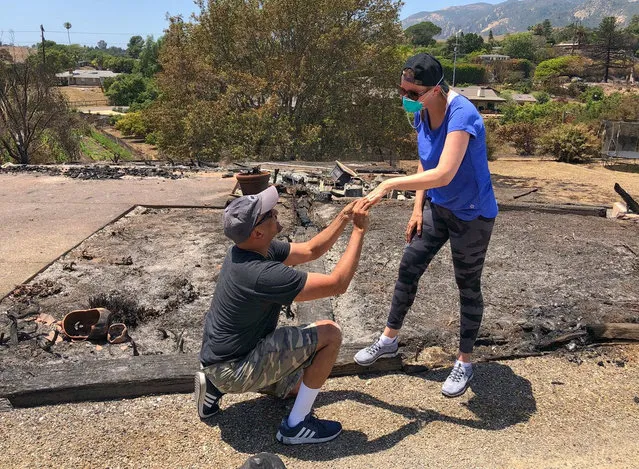 Ishu and Laura Rao, return to the rubble of their home which they lost in a wildfire, to retrieve their wedding ring, in Alameda, California, U.S., in this July 8, 2018 photo obtained from social media. (Photo by Mike Eliason/Reuters/Santa Barbara County Fire Department)