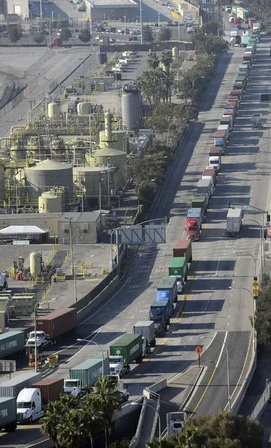 Transport trucks wait in a line at the ports of Los Angeles and Long Beach, California in this aerial photo taken February 6, 2015. (Photo by Bob Riha, Jr./Reuters)