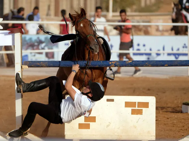 A rider falls from his horse during the Knights of Libya Festival in Benghazi, Libya August 7, 2018. (Photo by Esam Omran Al-Fetori/Reuters)