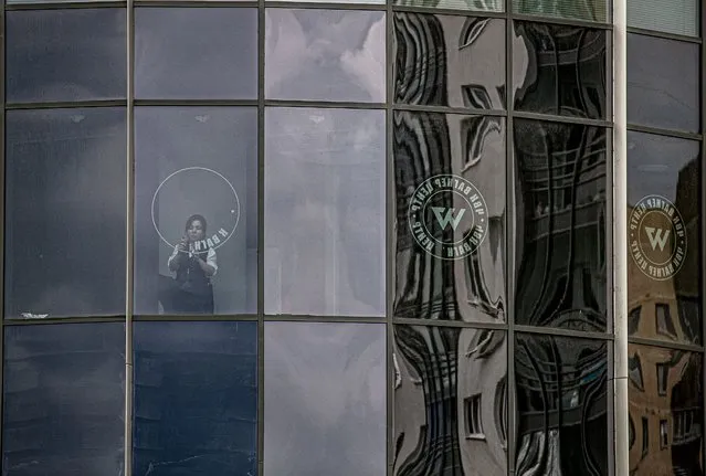 A worker removes the logo of the private military company (PMC) Wagner Group from the windows of the Sea Capital (Morskaya Stolitsa) business center, where Yevgeny Prigozhin's company rented several floors in St. Petersburg, Russia, 02 July 2023. On 23 June 2023, Wagner Group forces led by Prigozhin left the frontline in Ukraine and staged an 'armed mutiny' against Russia's military leadership. Prigozhin claimed on 24 June 2023 that his troops had occupied the headquarters of the Southern Military District in Rostov-on-Don, Russia, a key city near the Ukrainian border. A deal negotiated by the Belarusian president with Prigozhin stopped the Wagner forces' movement toward Moscow and ended the standoff, with Prigozhin and his fighters leaving the country. (Photo by Anatoly Maltsev/EPA)