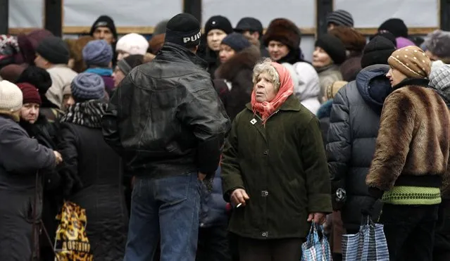Residents gather as the humanitarian aid is distributed to residents in the town of Debaltseve, Ukraine, Friday, February 6, 2015. (Photo by Petr David Josek/AP Photo)