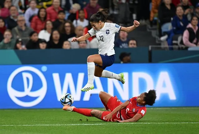 Panama's defender #05 Yomira Pinzon (bottom) attempts a tackle on France's forward #12 Clara Mateo during the Australia and New Zealand 2023 Women's World Cup Group F football match between Panama and France at Sydney Football Stadium in Sydney on August 2, 2023. (Photo by Jaimi Joy/Reuters)