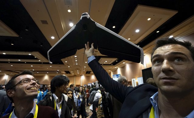 Representatives from the French company Parrot demonstrate a prototype of their new Disco drone at the opening event at the Consumer Electronics Show in Las Vegas January 4, 2016. The Disco is the first wing-shaped drone which a user can pilot with no learning process, according to the company. (Photo by Rick Wilking/Reuters)