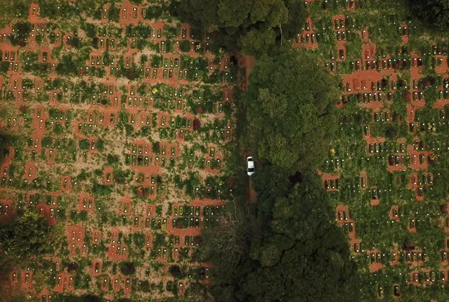 A car is seen between graves at Vila Formosa cemetery during the outbreak of coronavirus disease (COVID-19), in Sao Paulo, Brazil, March 23, 2021. Picture taken with a drone. (Photo by Amanda Perobelli/Reuters)