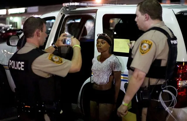 Police take a mug shot of a protester who was detained in Ferguson, Missouri, August 10, 2015. (Photo by Rick Wilking/Reuters)