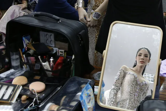 A contestant for Miss Tiffany's Universe Thailand 2018 is seen in a mirror as she gets ready backstage during the annual transgender beauty contest “Miss Tiffany's Universe Thailand 2018” at the Tiffany's Show Theatre in Pattaya city, Chonburi province, Thailand, 31 August 2018. (Photo by Narong Sangnak/EPA/EFE)