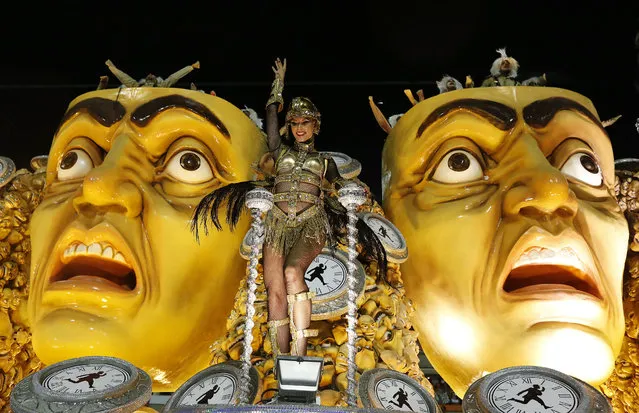 A performer from the Mocidade samba school greets spectators from a float during Carnival celebrations at the Sambadrome in Rio de Janeiro, Brazil, Monday, February 16, 2015. (Photo by Leo Correa/AP Photo)