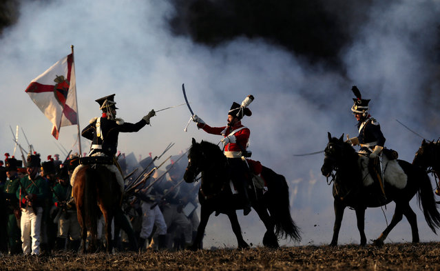 History enthusiasts, dressed as soldiers, fight during the re-enactment of Napoleon's famous battle of Austerlitz near the southern Moravian town of Slavkov u Brna, Czech Republic December 3, 2016. (Photo by David W. Cerny/Reuters)