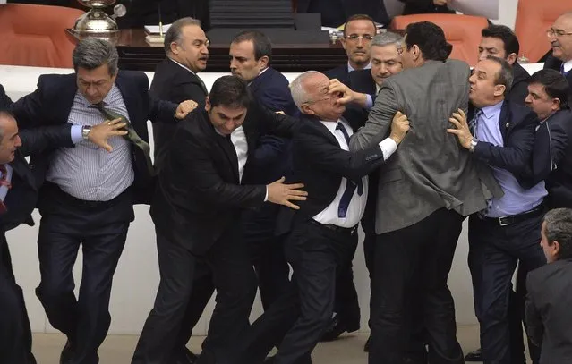 Lawmakers from the main opposition Republican People's Party (CHP) and ruling AK Party (R) scuffle during a debate on a legislation to boost police powers, at the Turkish Parliament in Ankara late February 19, 2015. The legislation, which would bolster the powers of the authorities to control protests. (Photo by Reuters/Stringer)