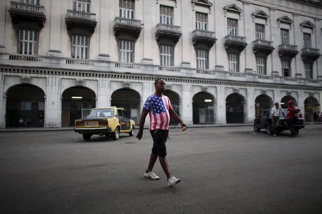 Street seller Orlando Hernandez, 38, walks in downtown Havana, July 21, 2015. (Photo by Alexandre Meneghini/Reuters)