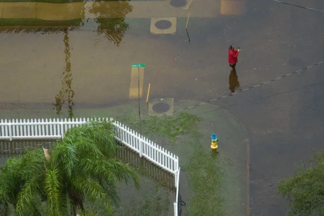 A man photographs floodwaters outside his resident in the aftermath of Hurricane Idalia in Tarpon Springs, Florida, U.S., August 30, 2023. (Photo by Adrees Latif/Reuters)