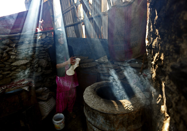 An Afghani woman prepares traditional bread at her home in Kabul, Afghanistan, Saturday, February 14, 2015. (Photo by Rahmat Gul/AP Photo)