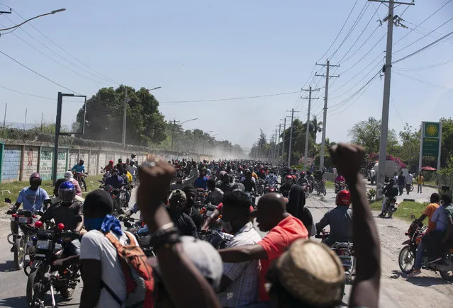 Demonstrators and disgruntled police officers protest in Port-au-Prince, Haiti, Wednesday, March 17, 2021. (Photo by Dieu Nalio Chery/AP Photo)