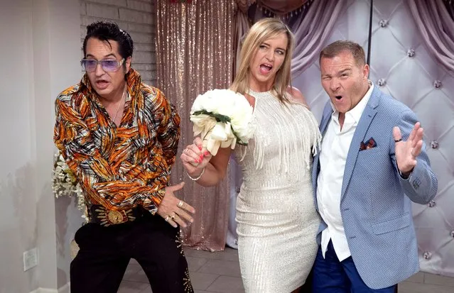 Elvis Presley tribute artist Jesse Garon poses with Juliet and Stuart Williams, of Nottingham, England, during their 10-year marriage vow renewal ceremony at Little Chapel of Hearts in Las Vegas, Nevada, U.S. June 1, 2022. (Photo by Steve Marcus/Reuters)