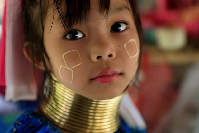 An Ethnic Kayan also know as a Long Neck girl sits at her parents souvenir shop in the Kayan village at the northern province of Chiang Rai, Thailand, July 16, 2018. (Photo by Soe Zeya Tun/Reuters)