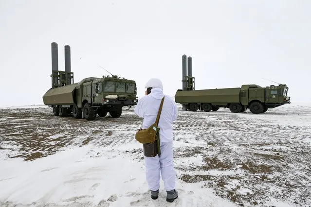 An officer speaks on walkie-talkie as the Bastion anti-ship missile systems take positions on the Alexandra Land island near Nagurskoye, Russia, Monday, May 17, 2021. Bristling with missiles and radar, Russia's northernmost military base projects the country's power and influence across the Arctic from a remote, desolate island amid an intensifying international competition for the region's vast resources. Russia's northernmost military outpost sits on the 80th parallel North, projecting power over wide swathes of Arctic amid an intensifying international rivalry over the polar region's vast resources. (Photo by Alexander Zemlianichenko/AP Photo)